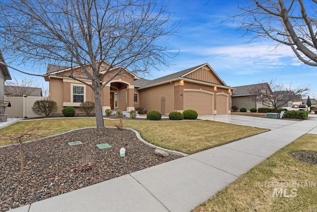 view of front of property featuring a front lawn, fence, board and batten siding, concrete driveway, and a garage