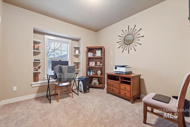 sitting room with baseboards, carpet floors, and a textured ceiling