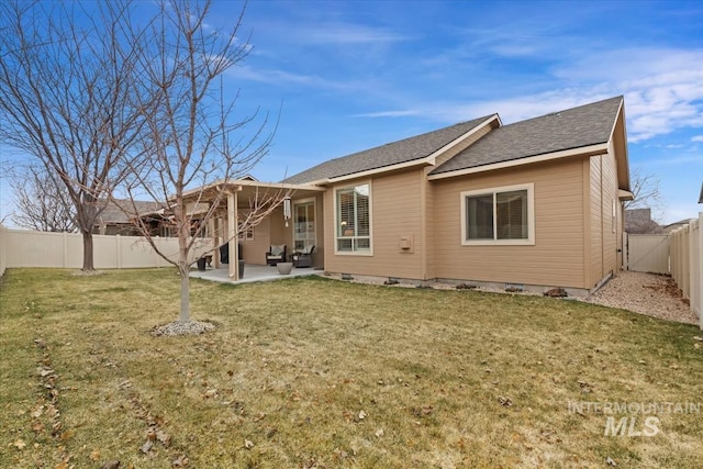 back of property with a shingled roof, crawl space, a yard, a fenced backyard, and a patio area