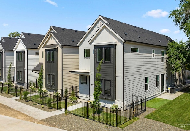 townhome / multi-family property featuring cooling unit and a front lawn