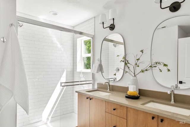 bathroom featuring vanity and a shower with shower door