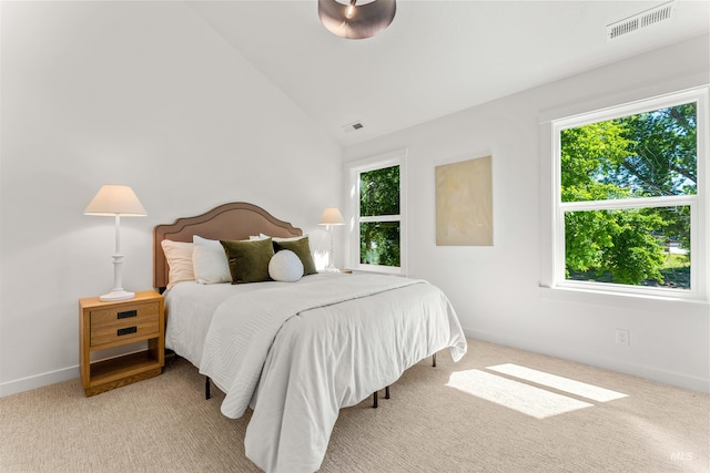 bedroom featuring vaulted ceiling and light colored carpet