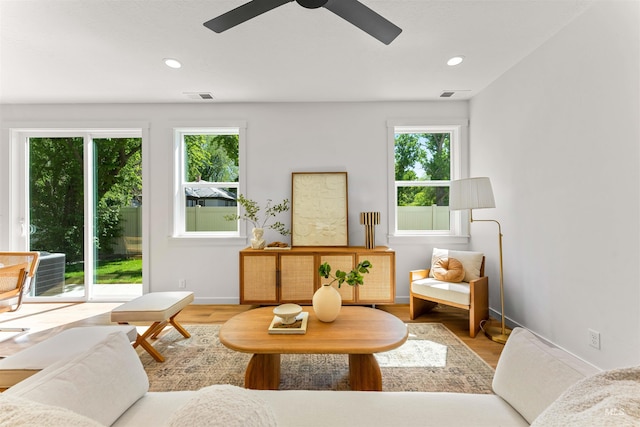 sitting room with light hardwood / wood-style floors and ceiling fan