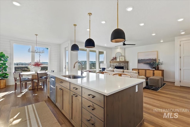 4608 N Alameda Creek Ave, Meridian, ID 83646 - kitchen with recessed lighting, wood finished floors, light countertops, a fireplace, and a sink