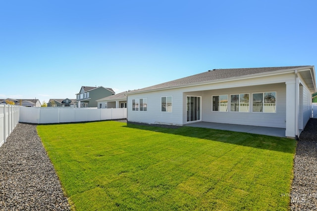 back of house with a lawn