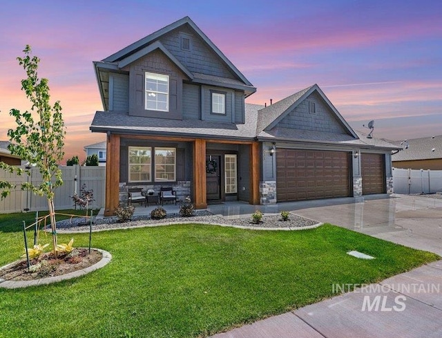 633 Reese Rd, Twin Falls, ID 83301 - craftsman-style house with driveway, an attached garage, covered porch, and stone siding