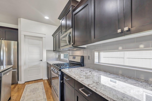 633 Reese Rd, Twin Falls, ID 83301 - kitchen with stainless steel appliances, light stone countertops, tasteful backsplash, light wood-style flooring, and recessed lighting