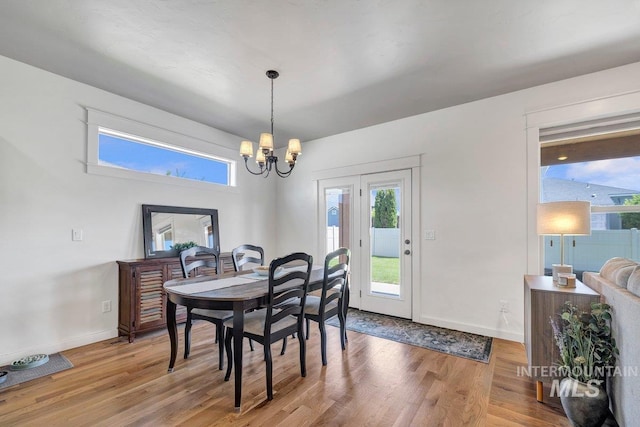 633 Reese Rd, Twin Falls, ID 83301 - dining room with a chandelier, light wood-type flooring, and healthy amount of natural light