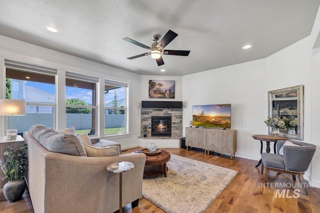 633 Reese Rd, Twin Falls, ID 83301 - living area featuring a ceiling fan, a fireplace, wood finished floors, and recessed lighting