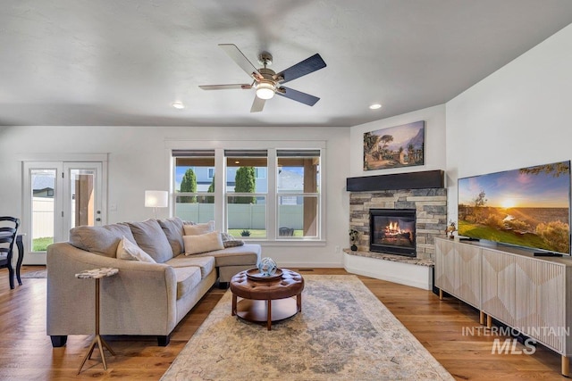 633 Reese Rd, Twin Falls, ID 83301 - living area featuring a ceiling fan, a fireplace, wood finished floors, and recessed lighting