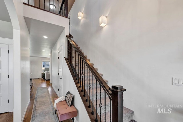 633 Reese Rd, Twin Falls, ID 83301 - stairs with wood finished floors, arched walkways, a towering ceiling, and recessed lighting