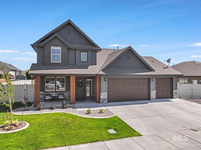 633 Reese Rd, Twin Falls, ID 83301 - craftsman-style home featuring a garage, a porch, a gate, and stone siding