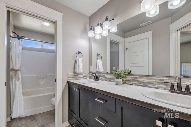 633 Reese Rd, Twin Falls, ID 83301 - full bathroom with double vanity, shower / bathtub combination with curtain, and backsplash