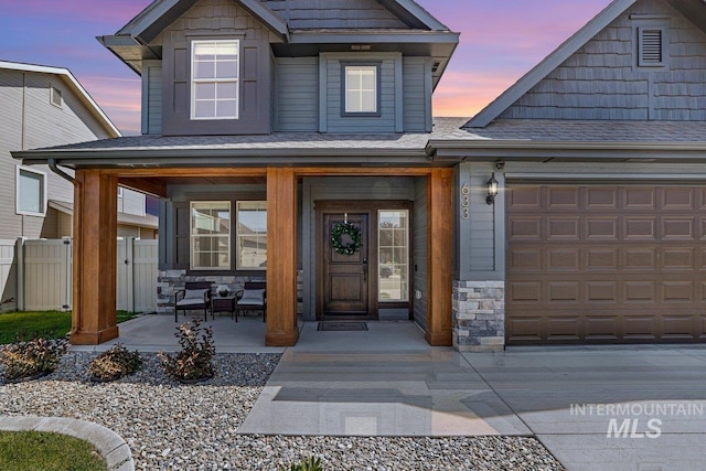 633 Reese Rd, Twin Falls, ID 83301 - view of exterior entry with covered porch, stone siding, and an attached garage
