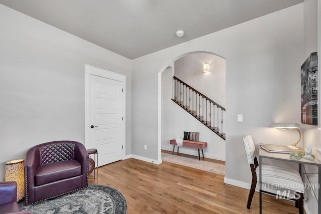 633 Reese Rd, Twin Falls, ID 83301 - sitting room with arched walkways, stairs, and wood finished floors