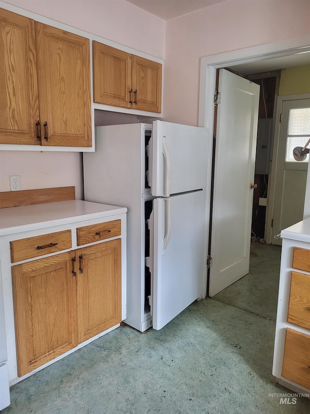 240 N D St, Orofino, ID 83544 - kitchen with brown cabinetry, light countertops, and freestanding refrigerator