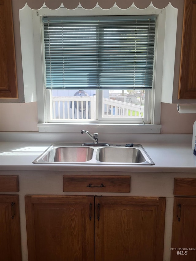 240 N D St, Orofino, ID 83544 - kitchen with light countertops, brown cabinets, and a sink