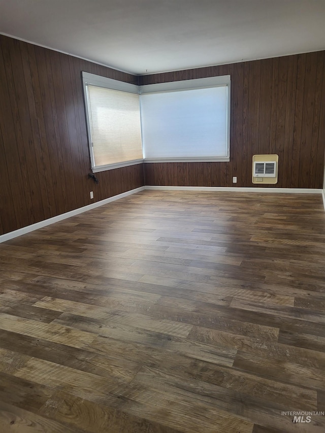 240 N D St, Orofino, ID 83544 - unfurnished room with wooden walls, heating unit, and dark wood-style floors