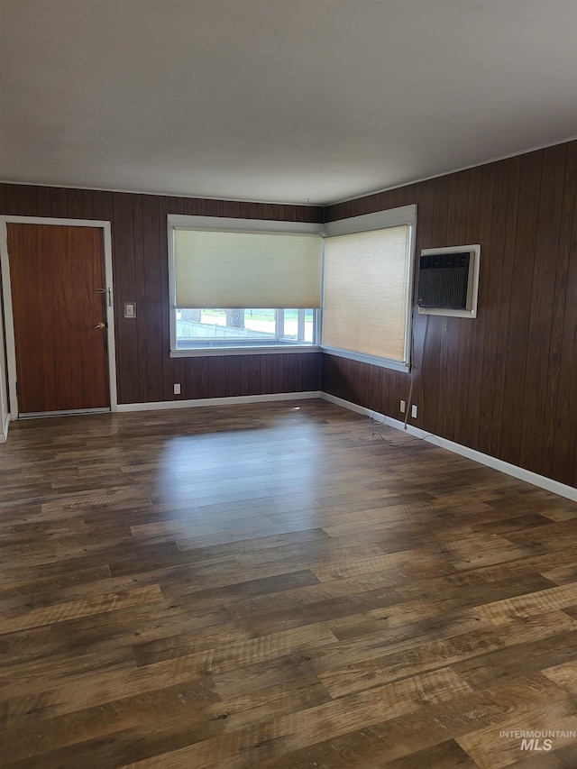 240 N D St, Orofino, ID 83544 - spare room with dark wood-type flooring, wood walls, and a wall mounted AC
