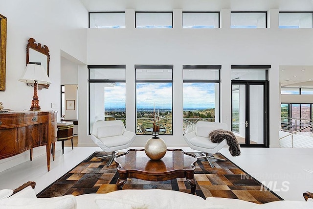 living room featuring french doors and a towering ceiling