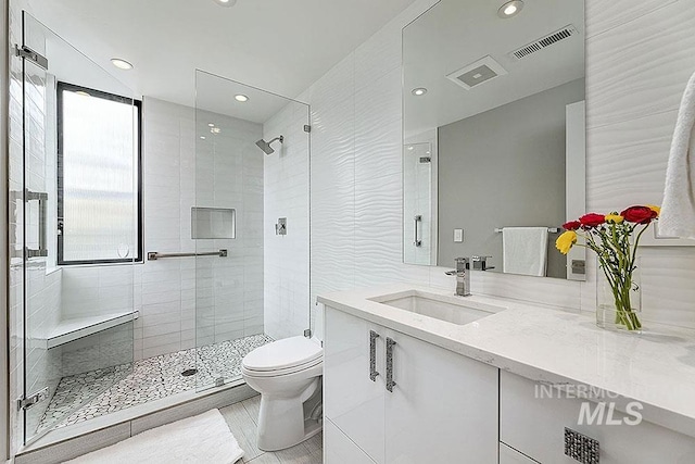 bathroom with vanity, an enclosed shower, and toilet