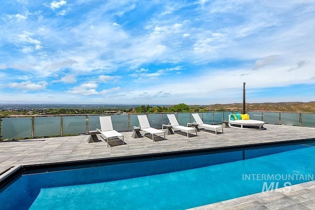 view of pool with a water view