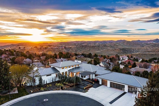 aerial view at dusk featuring a mountain view