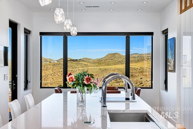 dining area with a mountain view and sink