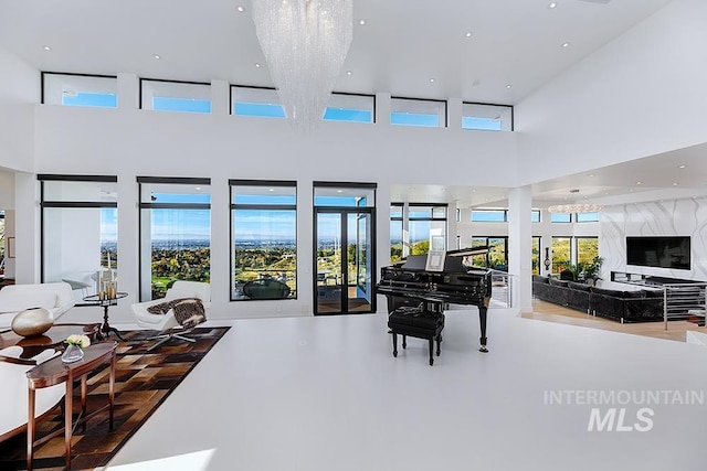 miscellaneous room with a towering ceiling and concrete floors