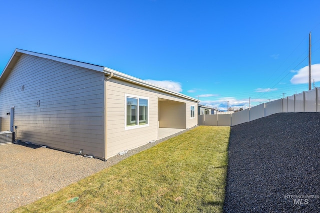 view of home's exterior featuring a fenced backyard and a yard