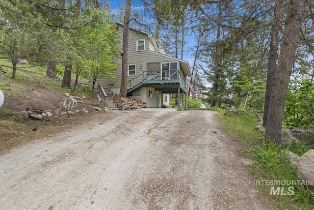 122 Warm Springs Rd, Garden Valley, ID 83622 - view of front of property featuring stairs, dirt driveway, and a wooden deck