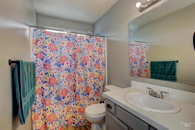 bathroom featuring vanity, toilet, and a shower with curtain