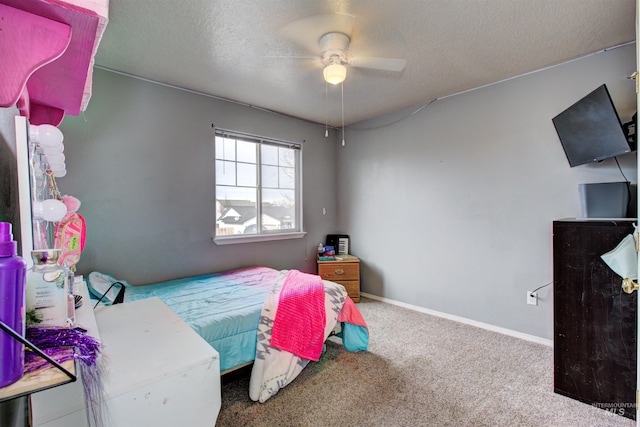 bedroom with a ceiling fan, carpet, baseboards, and a textured ceiling