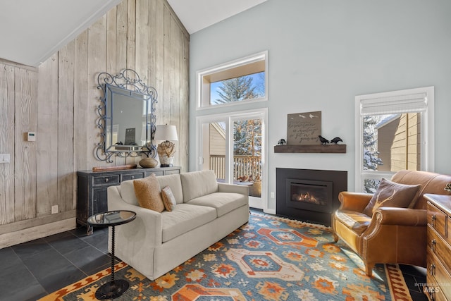 interior space with high vaulted ceiling and wooden walls