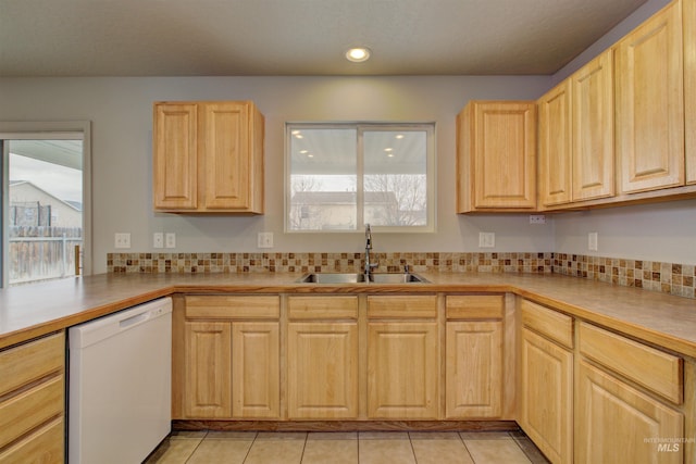 kitchen featuring white dishwasher, sink, tasteful backsplash, and light brown cabinets