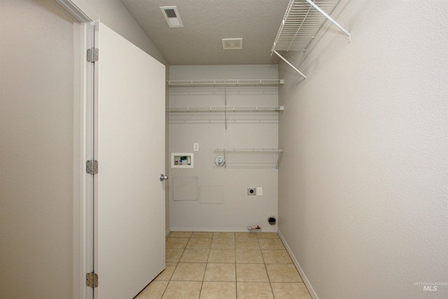 laundry area with gas dryer hookup, washer hookup, hookup for an electric dryer, and light tile patterned flooring