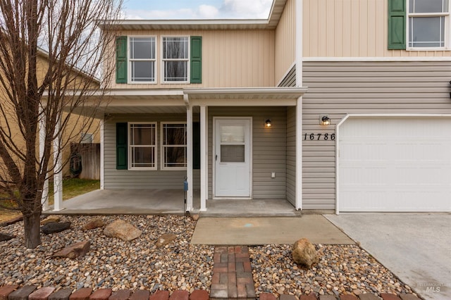 property entrance featuring a garage and covered porch