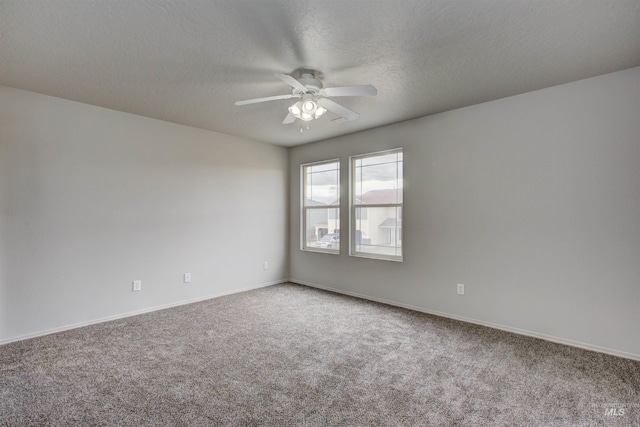 spare room featuring ceiling fan, carpet floors, and a textured ceiling