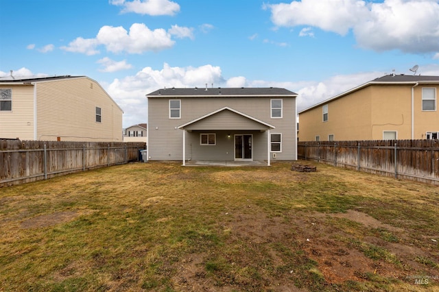 rear view of house with a yard and a patio area