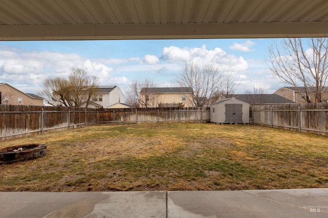 view of yard with a fire pit and a shed