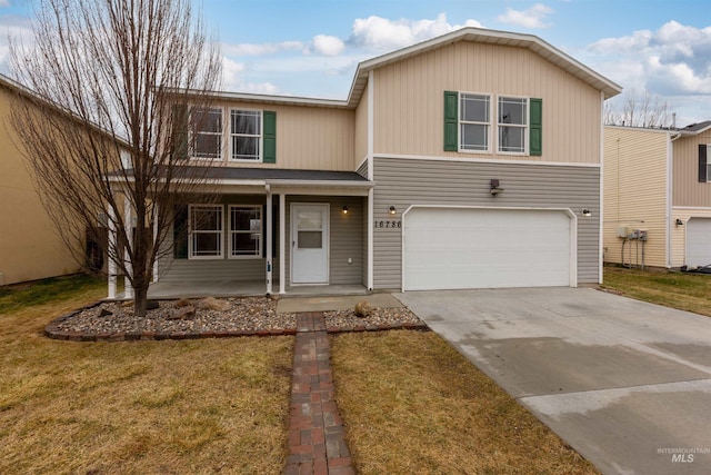 view of front of house featuring a garage, a front lawn, and a porch