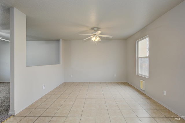 unfurnished room featuring light tile patterned flooring and ceiling fan