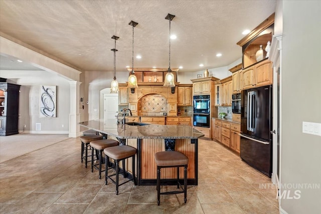 7406 Wild Horse Way, Nampa, ID 83686 - kitchen featuring a sink, a breakfast bar area, recessed lighting, tasteful backsplash, and black appliances