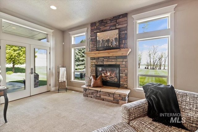 7406 Wild Horse Way, Nampa, ID 83686 - carpeted living room featuring baseboards, a textured ceiling, and a fireplace