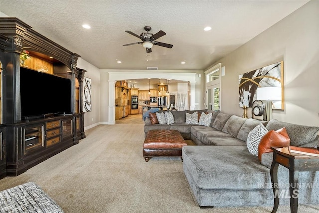7406 Wild Horse Way, Nampa, ID 83686 - living room with baseboards, light carpet, ceiling fan with notable chandelier, and recessed lighting