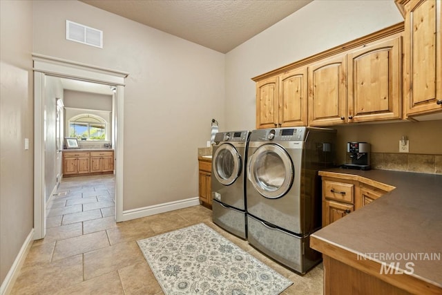 7406 Wild Horse Way, Nampa, ID 83686 - laundry room featuring cabinet space, baseboards, visible vents, and washing machine and dryer