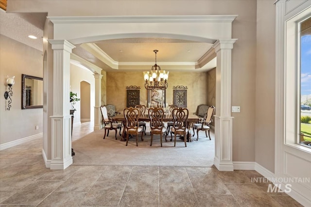 7406 Wild Horse Way, Nampa, ID 83686 - dining room with crown molding, arched walkways, ornate columns, and light colored carpet