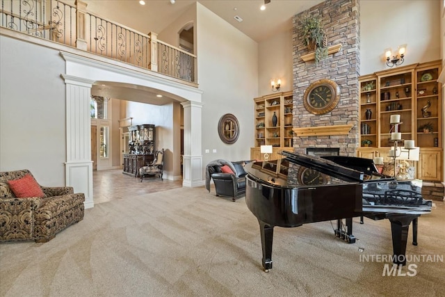 7406 Wild Horse Way, Nampa, ID 83686 - sitting room featuring carpet flooring, a fireplace, baseboards, a towering ceiling, and ornate columns