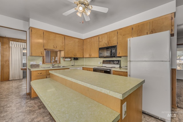 1040 N Pennsylvania Ave, Fruitland, ID 83619 - kitchen featuring white appliances, a sink, light countertops, a ceiling fan, and tasteful backsplash