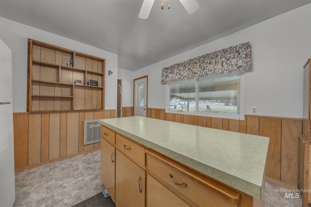 1040 N Pennsylvania Ave, Fruitland, ID 83619 - kitchen featuring a wainscoted wall, wood walls, a ceiling fan, light countertops, and heating unit